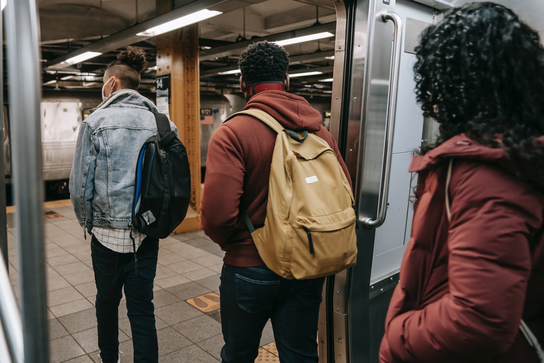 homeworksmontana. faceless multiethnic students walking out of subway train